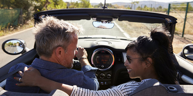 U.S. couple in an expat retirement abroad driving in car